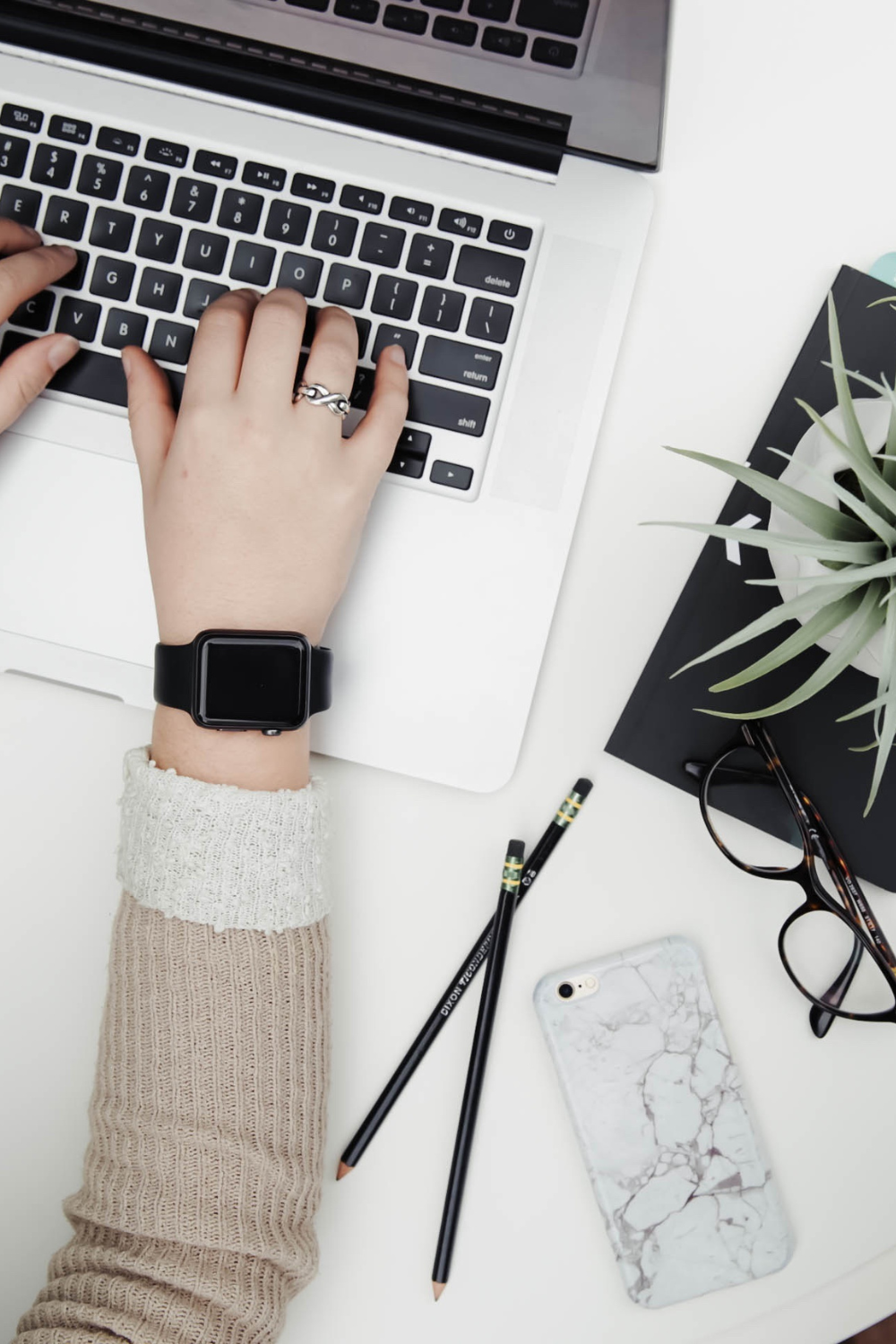 hands typing on a computer